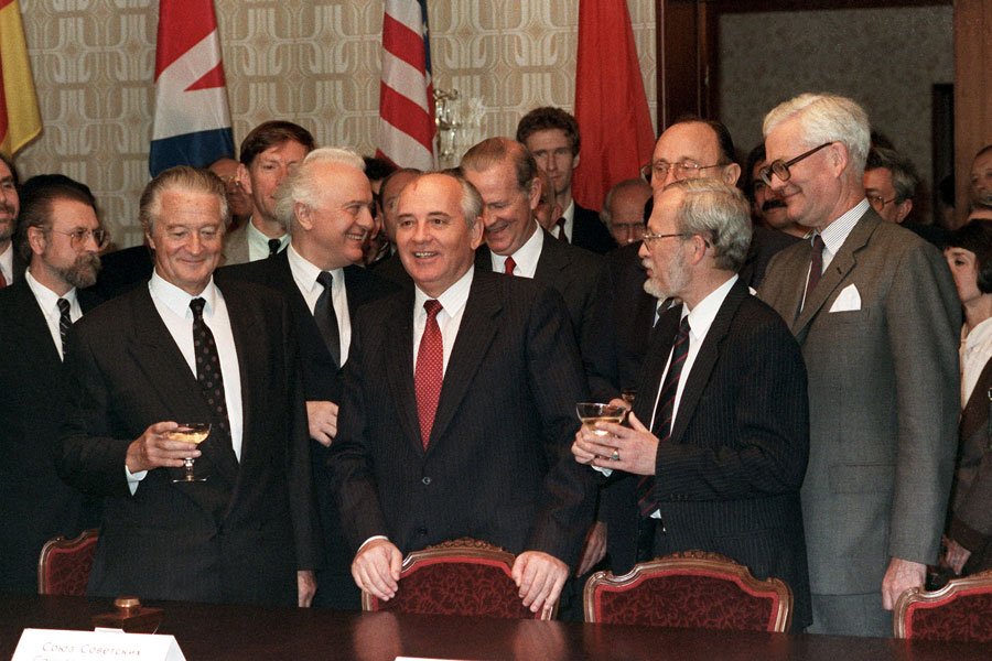 Die Außenminister Roland Dumas (Frankreich), Eduard Schewardnadse (UdSSR), der sowjetische Präsident Michail Gorbatschow (M), James Baker (USA), Hans-Dietrich Genscher (BRD), Lothar de Maiziere (DDR) und Douglas Hurd (Großbritannien) nach der Unterzeichnung des Zwei-plus-Vier-Vertrages im Moskauer Hotel "Oktober" am 12. September 1990. Quelle: picture-alliance/dpa)